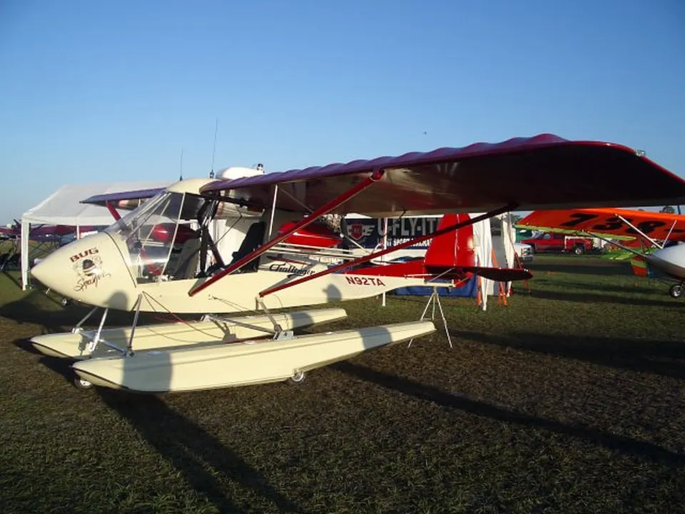 Red and white Challenger II on Puddle Jumper amphibious floats, parked on the grass