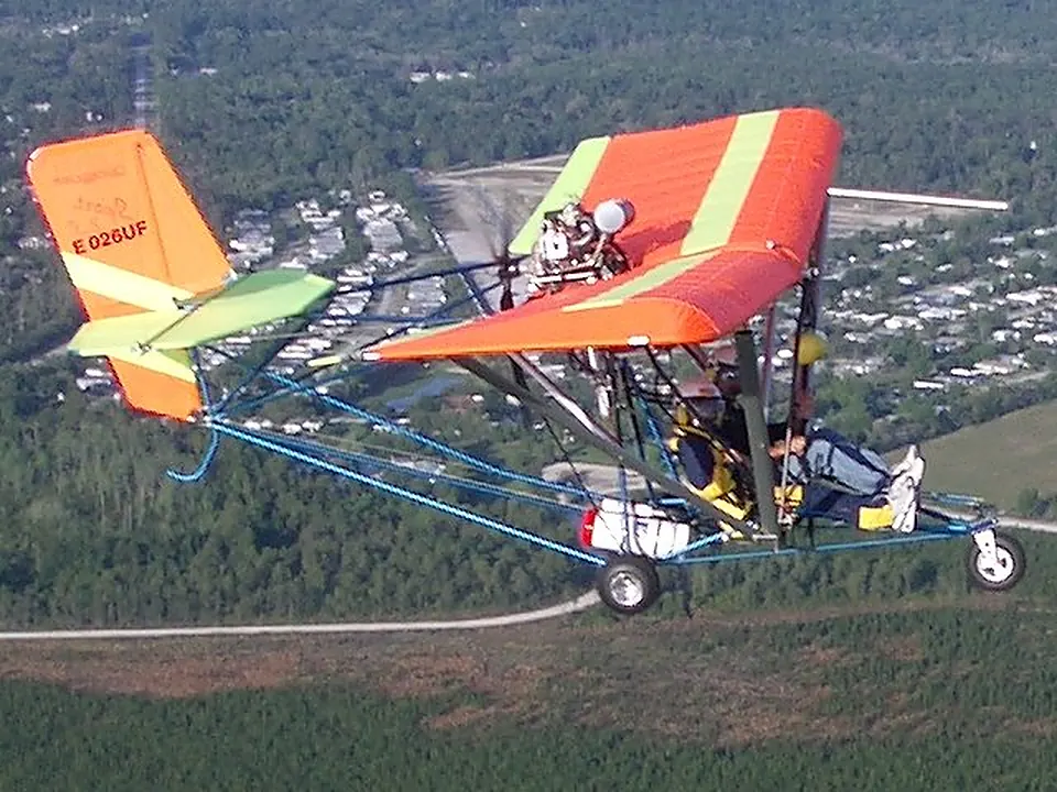 Orange and white Quicksilver Sport 2S in flight